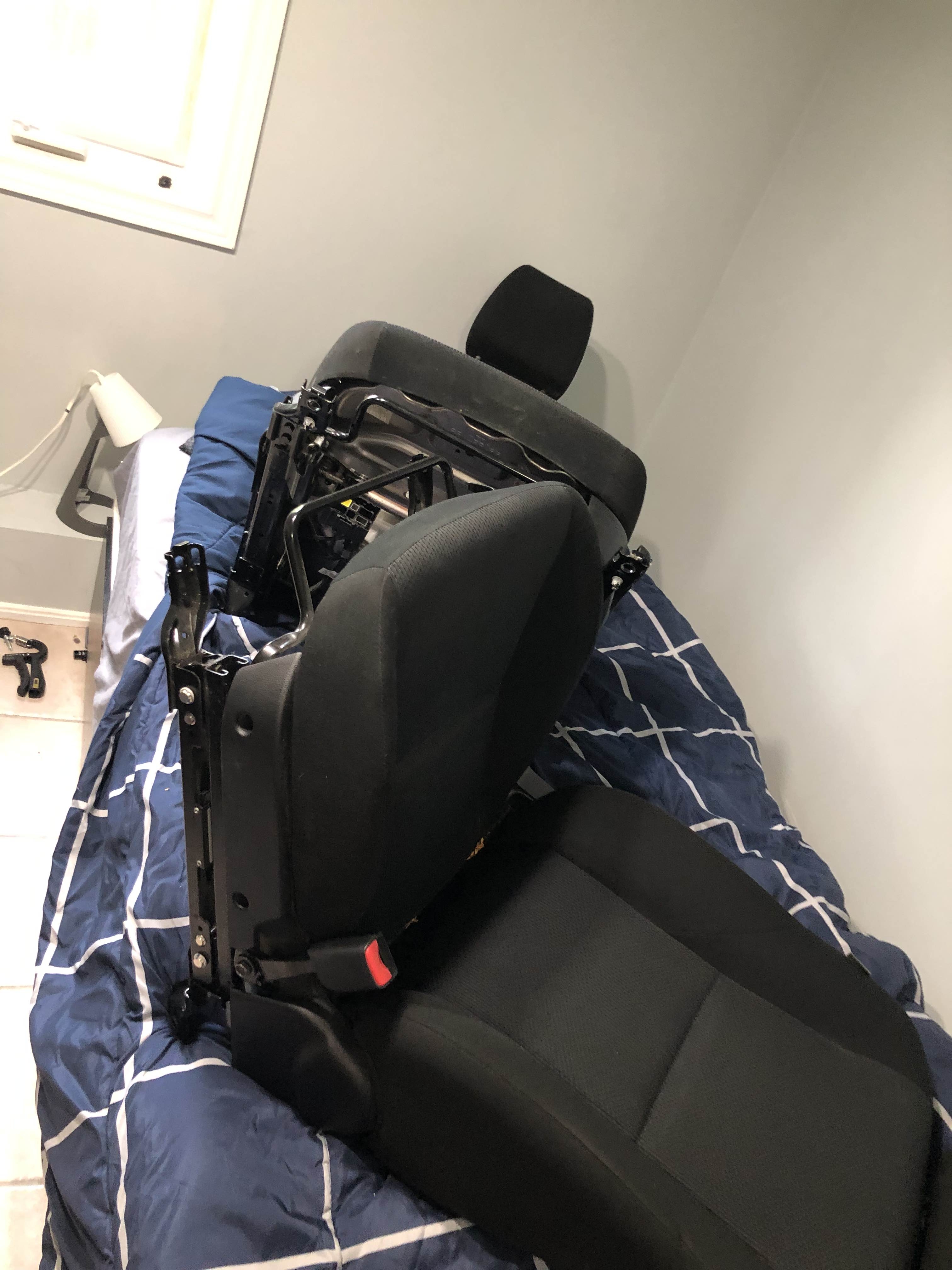 Car seats sitting on bed