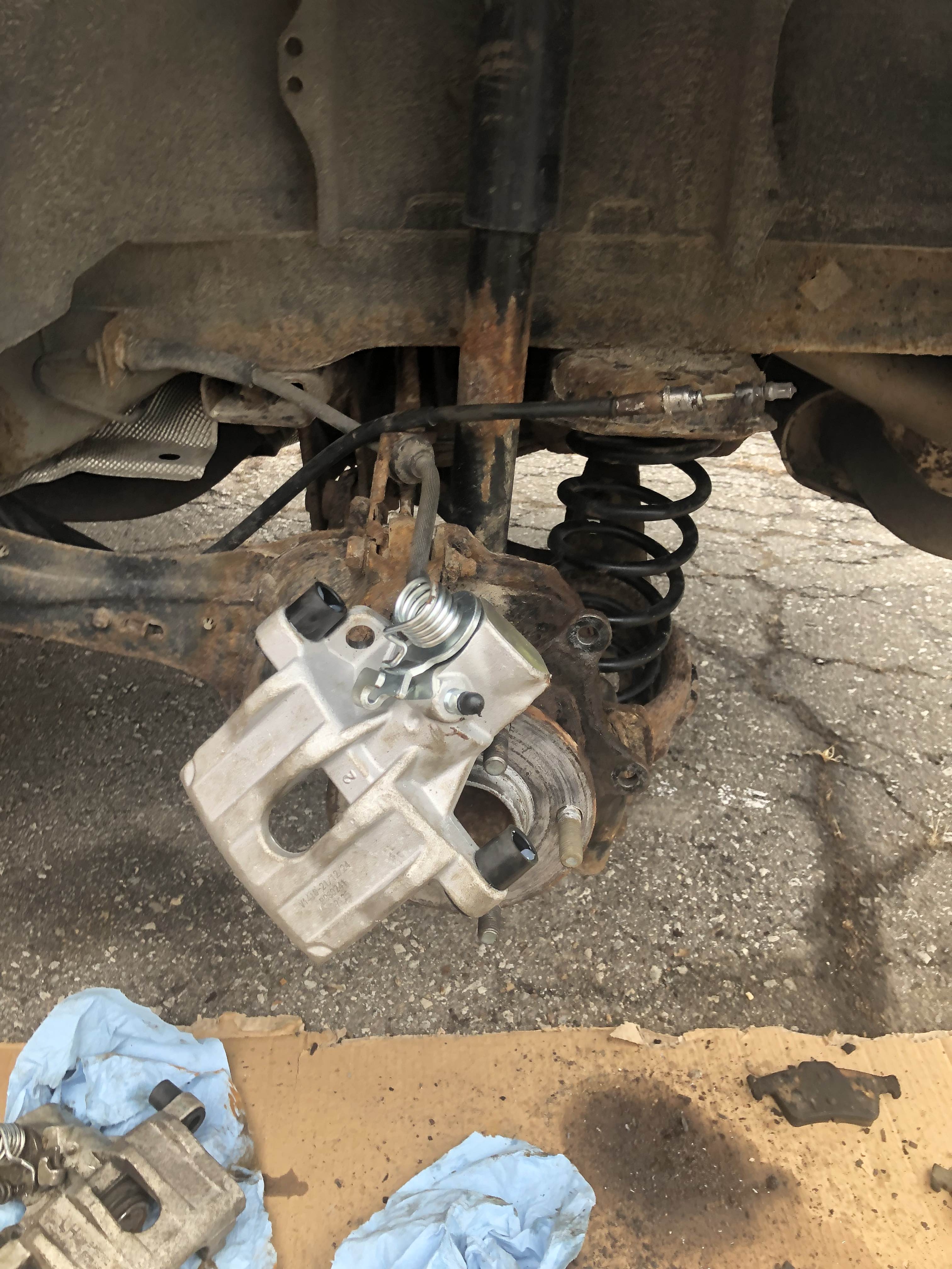 New caliper hanging by brake line