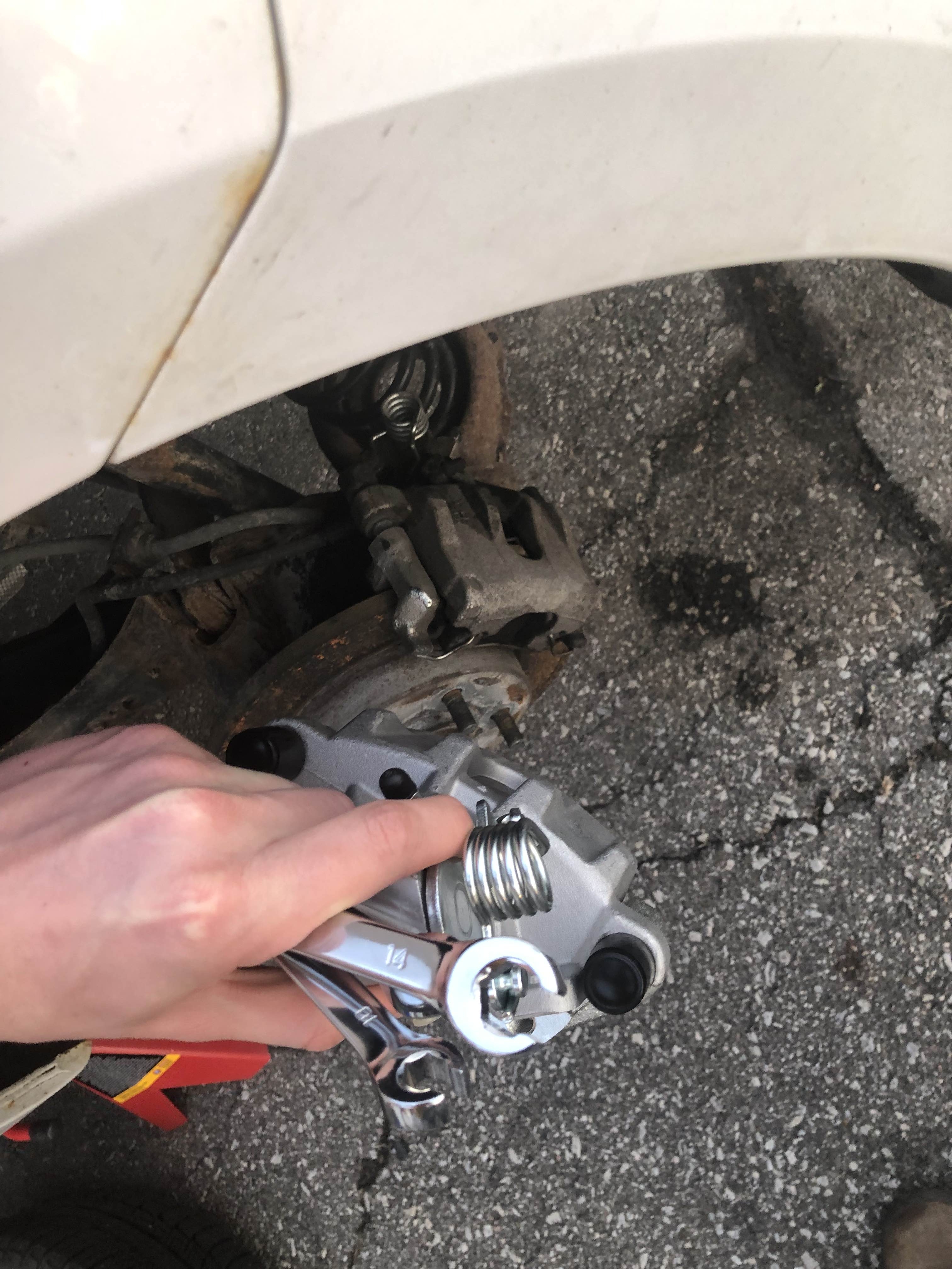 Holding new caliper with old one still installed