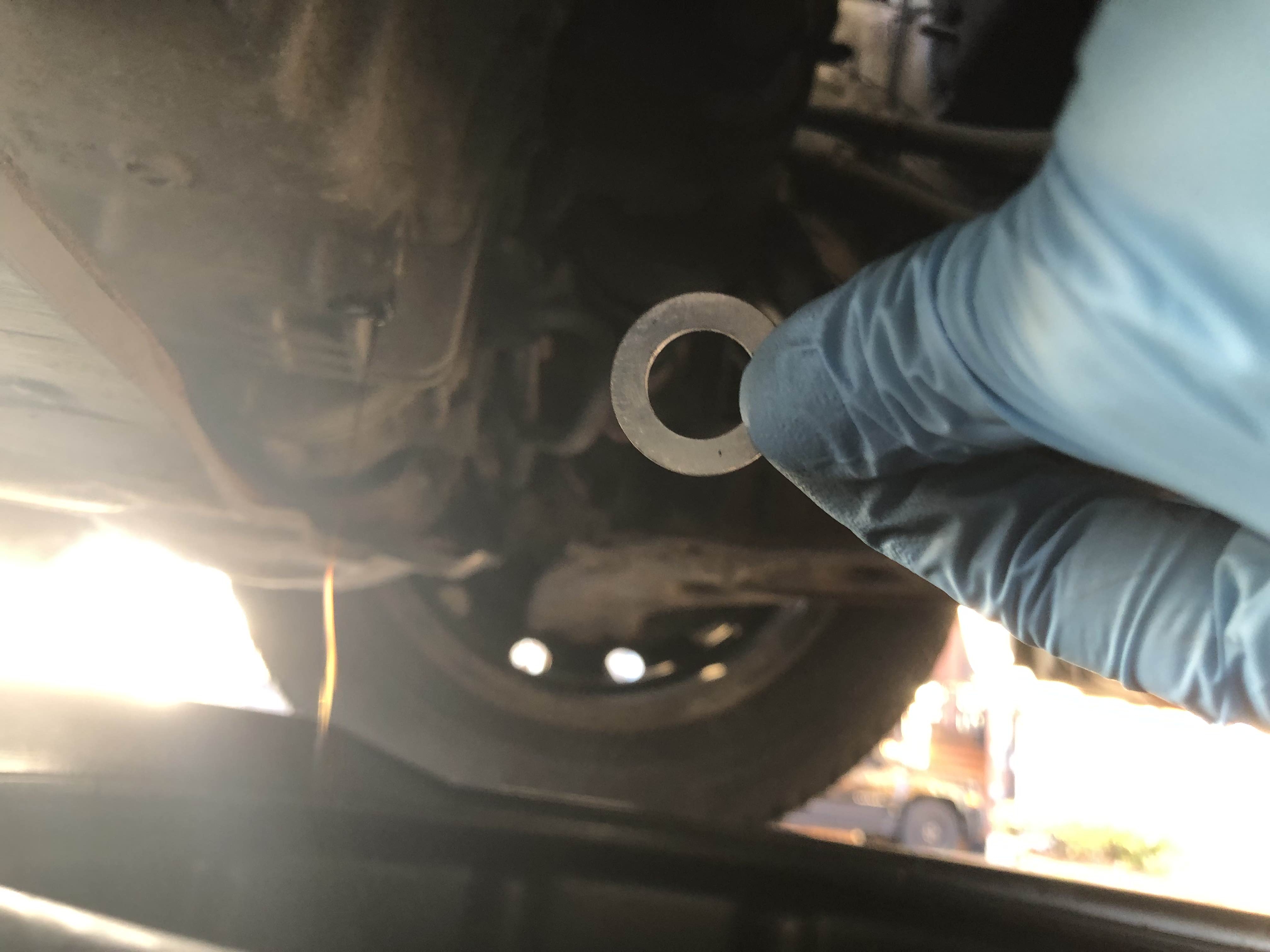 Bottom of car with visible oil dripping