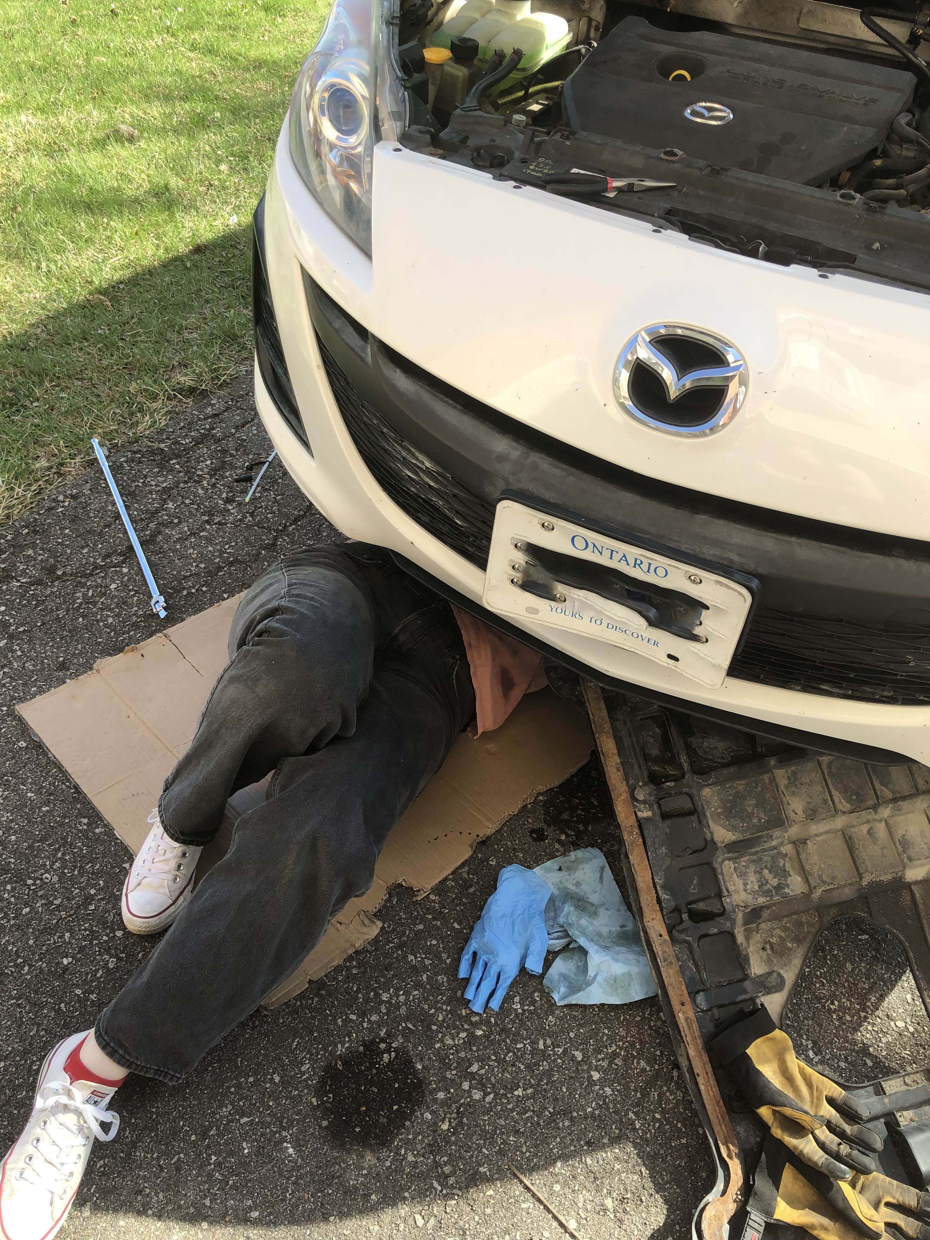 Person underneath car