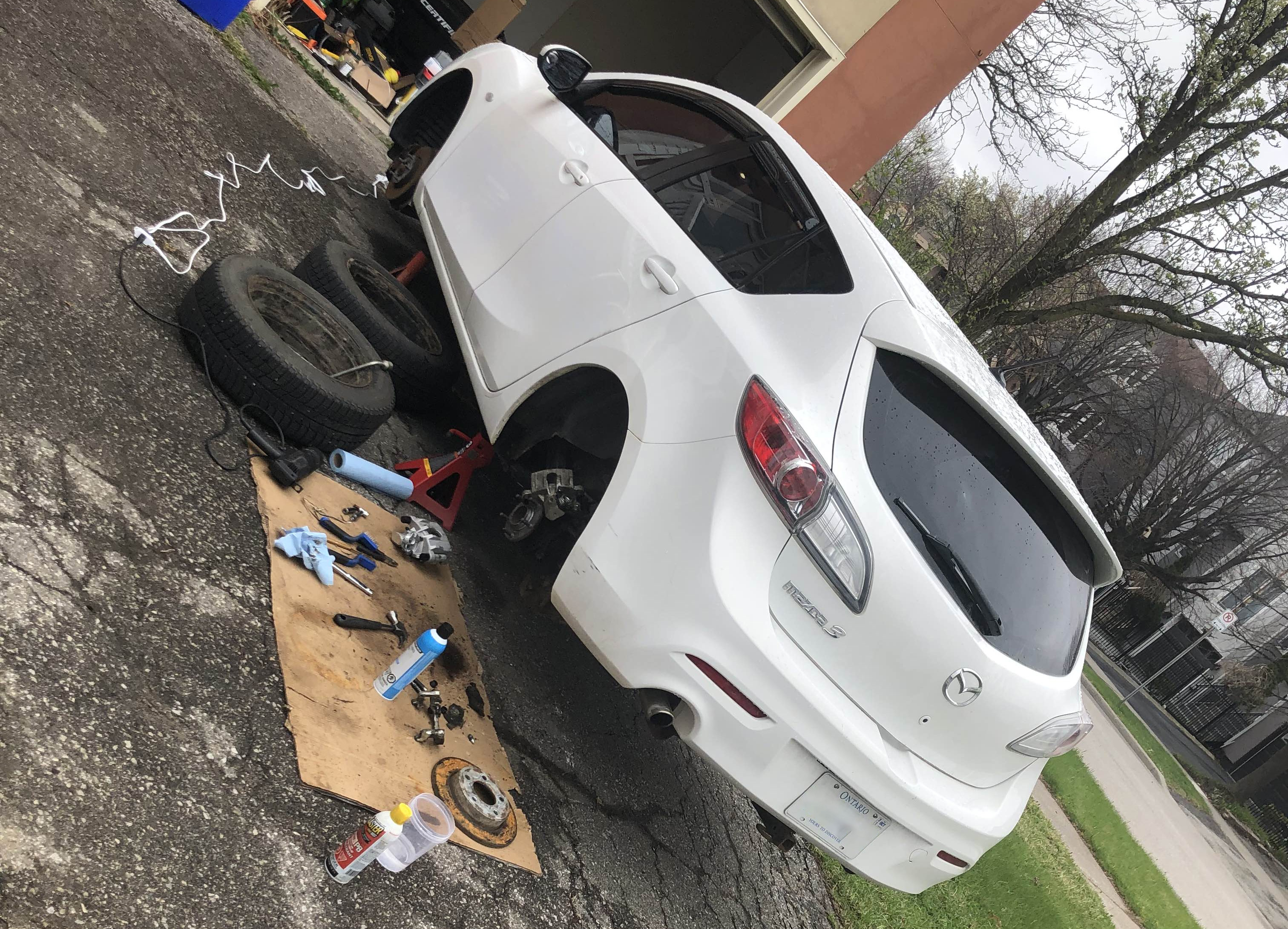 Mazda up in the air with no wheels