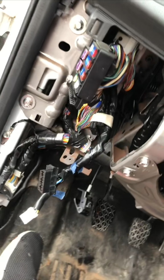 Photo of car wires behind the steering wheel