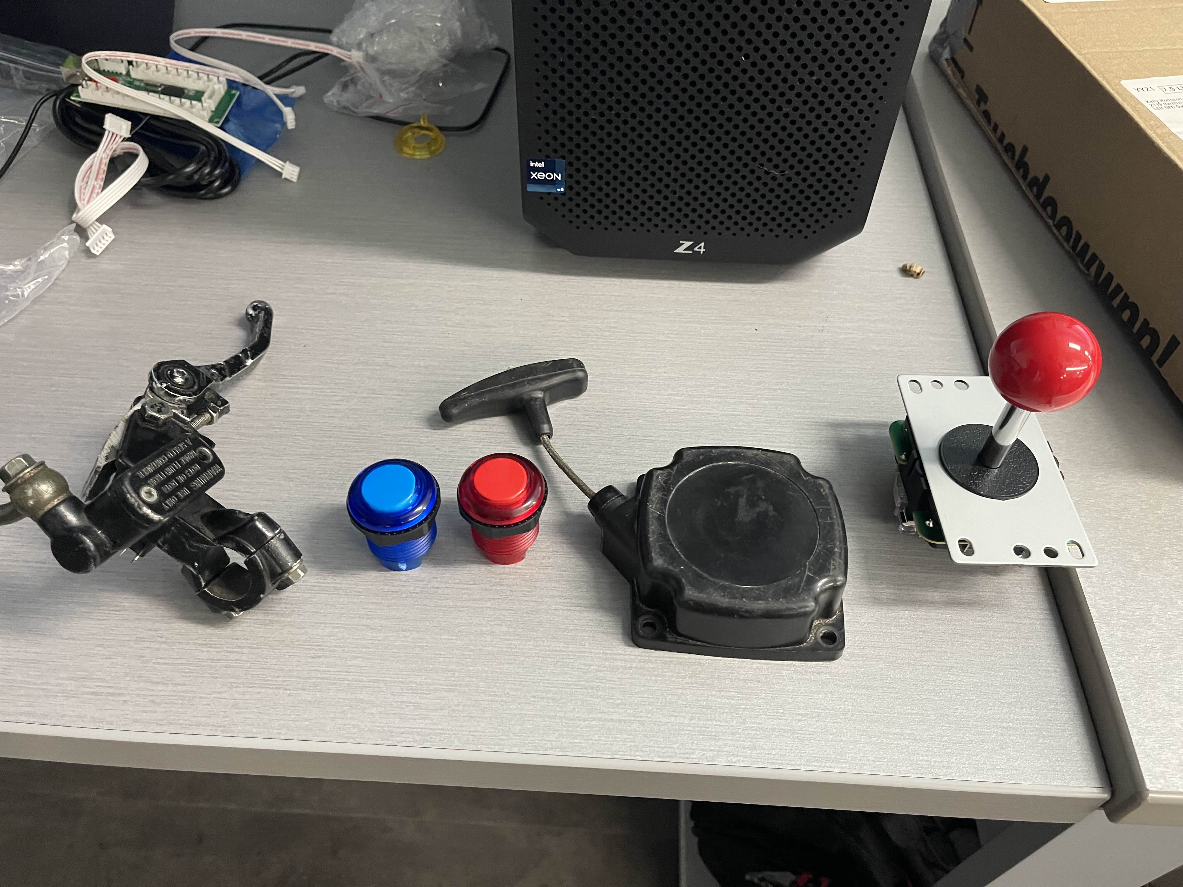 Arcade and minibike parts on desk