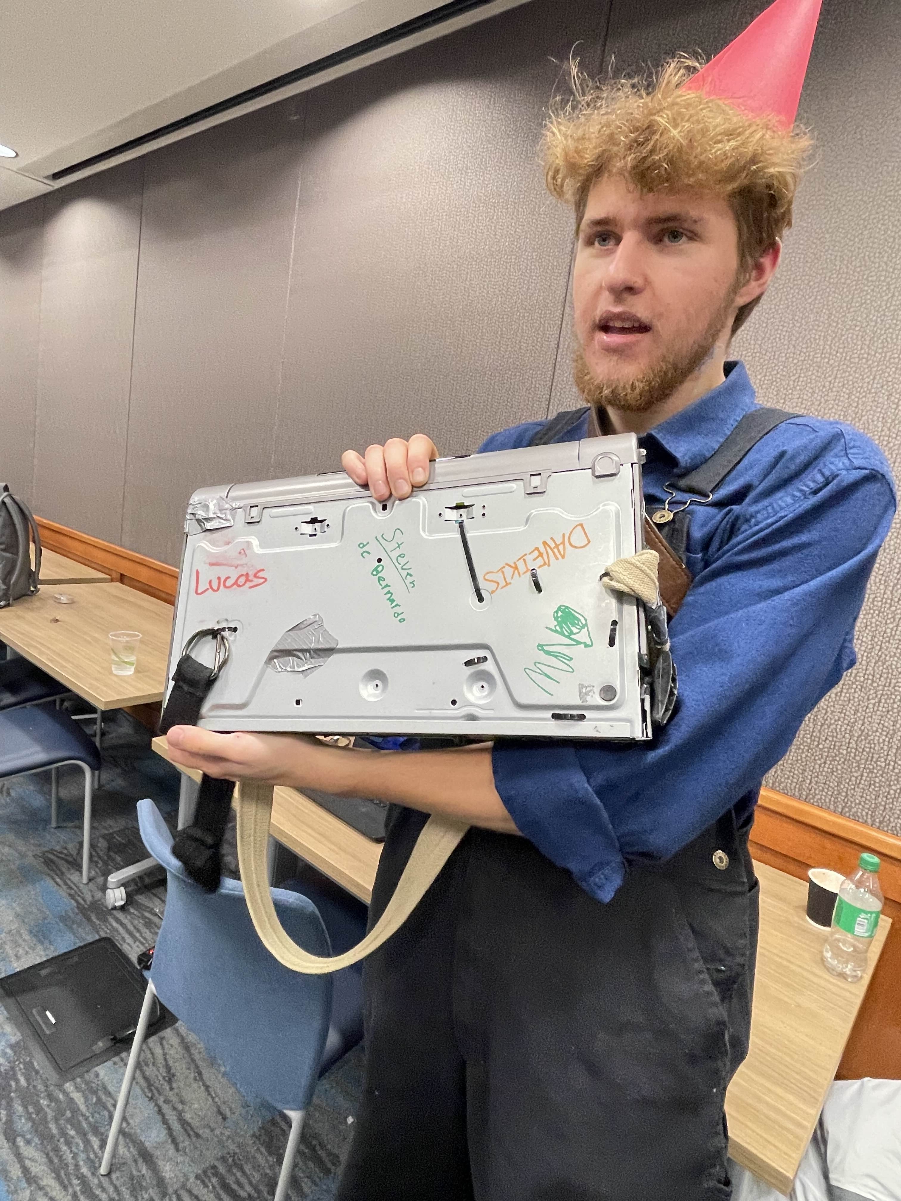 Holding instrument with team names signed on back